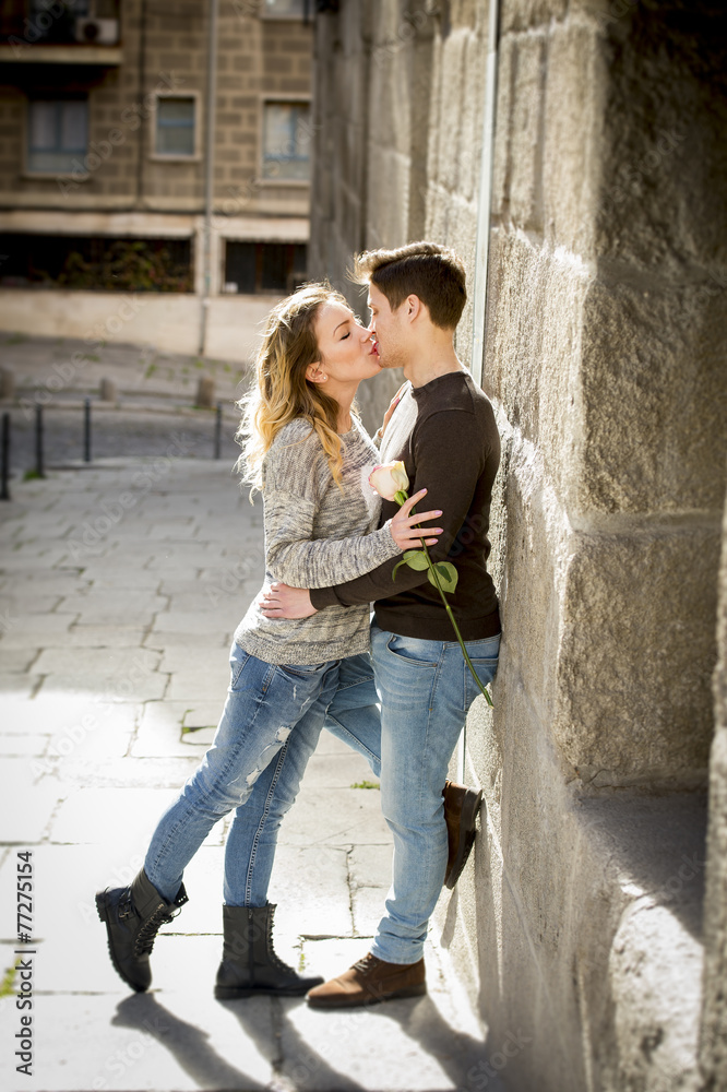 young couple in love kissing on street alley on Valentines day