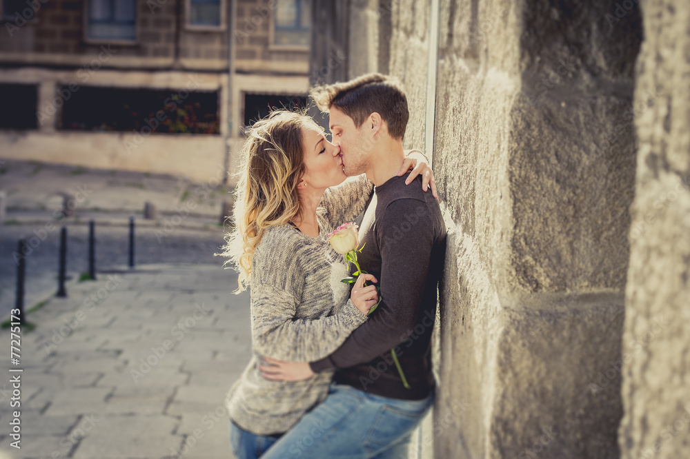 young couple in love kissing on street alley on Valentines day