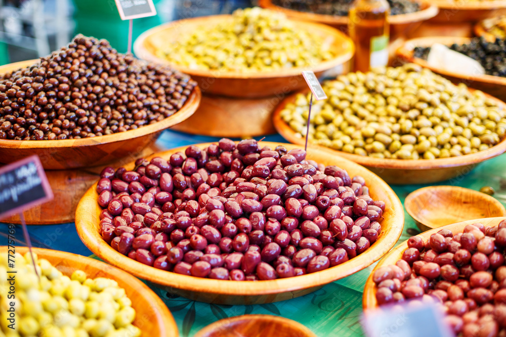 Different marinated olives on provencal street market in Provenc Different marinated olives on provencal street market in Provenc