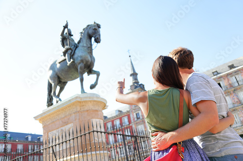 Madrid tourists on Plaza Mayor looking at statue