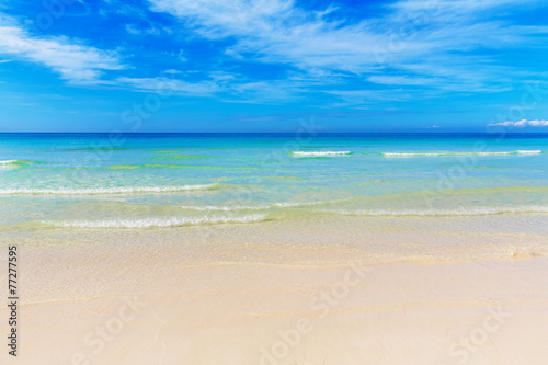 Tropical beach and beautiful sea. Blue sky with clouds in the ba