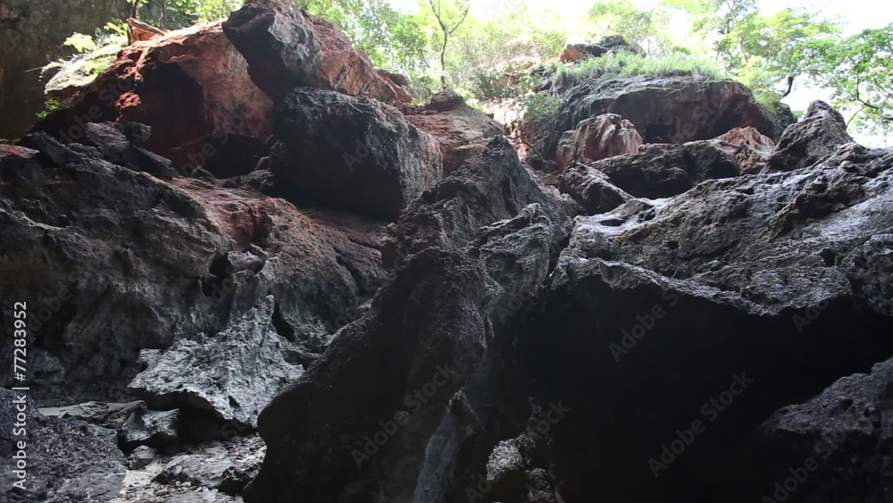 drops of water are running along dark rocky cliff drops of water are running along dark rocky cliff