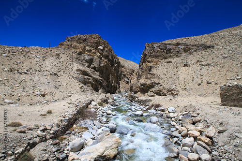 Tajikistan. Mountain stream flowing down the canyon with the bar