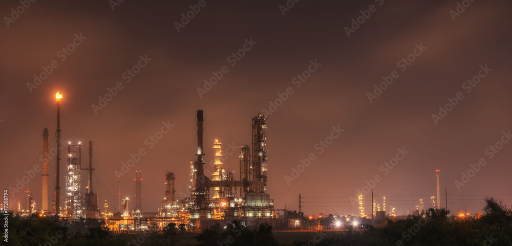 Big Industrial oil tanks in a refinery with treatment pond at in