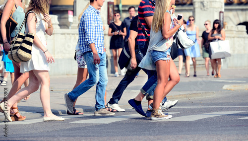 Fototapeta Naklejka Na Ścianę i Meble -  Sunlit summer pedestrians on zebra crossing