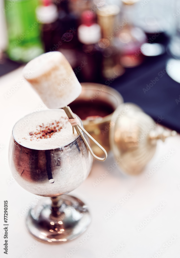Cocktail decorated with marshmallow in old metal goblet Cocktail decorated with marshmallow in old metal goblet