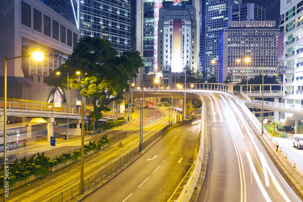 traffic light trails at modern city street,hongkong.