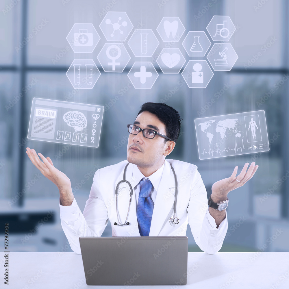 © Creativa Images - Male doctor and medical icon