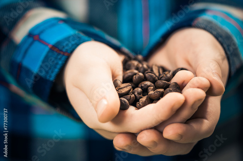 boy holding coffee beans in arms