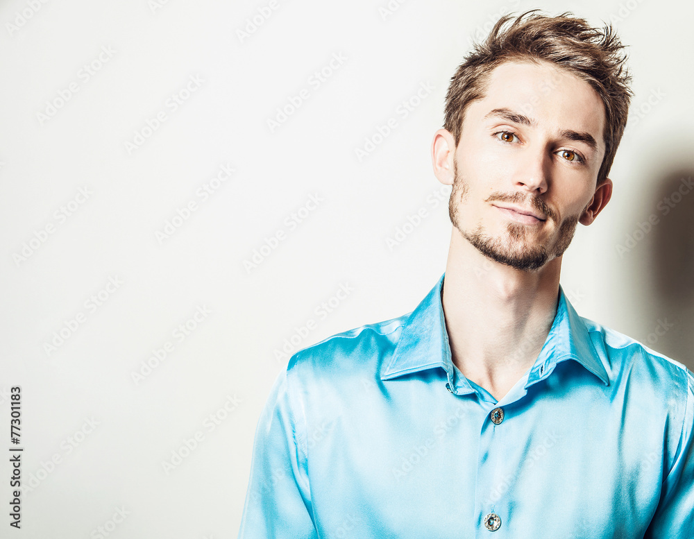 Elegant young handsome man in blue silk shirt. Elegant young handsome man in blue silk shirt.