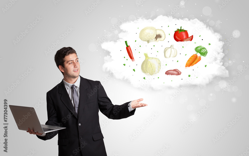 Handsome man presenting a cloud of healthy nutritional vegetable Handsome man presenting a cloud of healthy nutritional vegetable