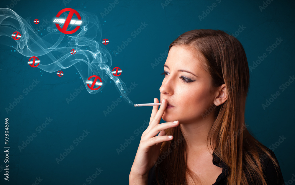 Obraz premium Young woman smoking dangerous cigarette with no smoking signs