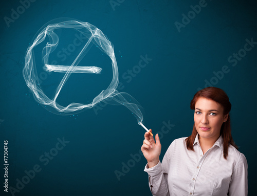 Young lady smoking unhealthy cigarette with no smoking sign