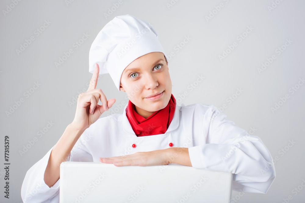 Smiling and cheerful female chef, cook or baker in uniform Smiling and cheerful female chef, cook or baker in uniform