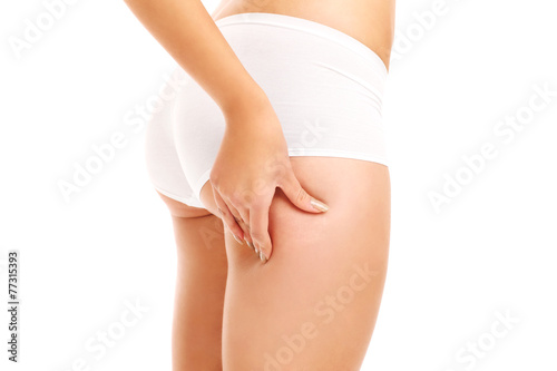 Woman checking skin on her butt © Kalim