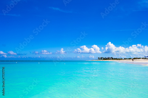 White sandy beach with turquoise water at perfect island