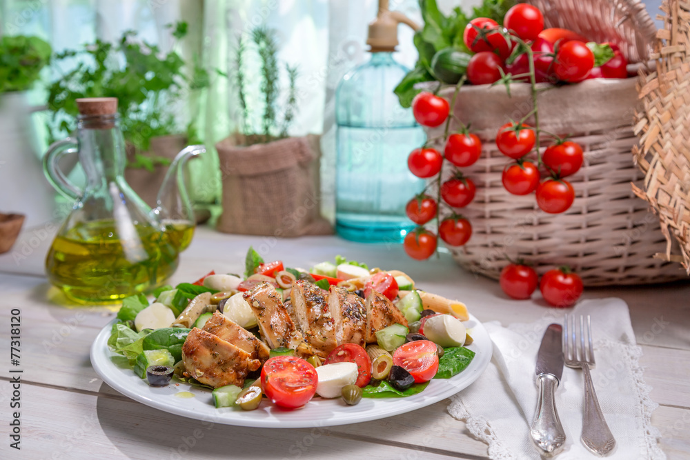 Salad with chicken cooked in a sunny kitchen