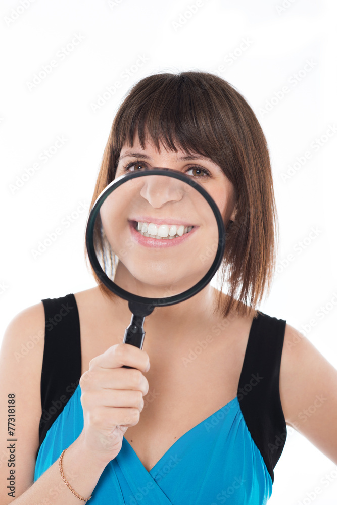 Magnifier. Young girl smiling through a magnifying glass Magnifier. Young girl smiling through a magnifying glass