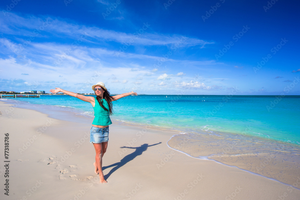 Young happy woman on beach during her summer vacation Young happy woman on beach during her summer vacation