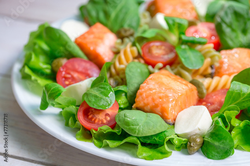 Salad with fresh vegetables and salmon