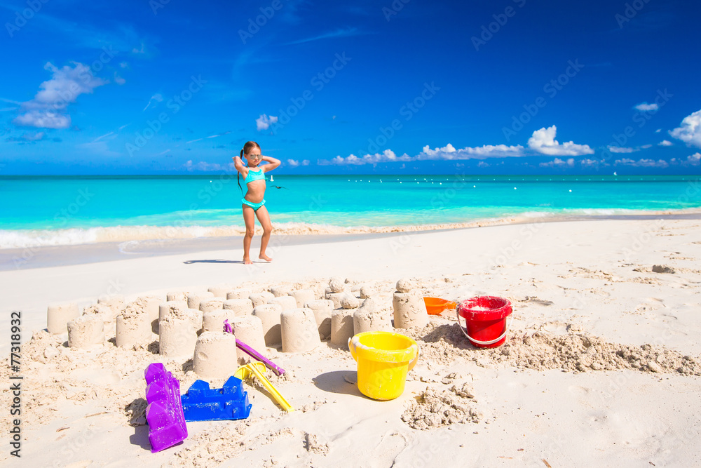 Little girl playing with beach toys during tropical vacation Little girl playing with beach toys during tropical vacation