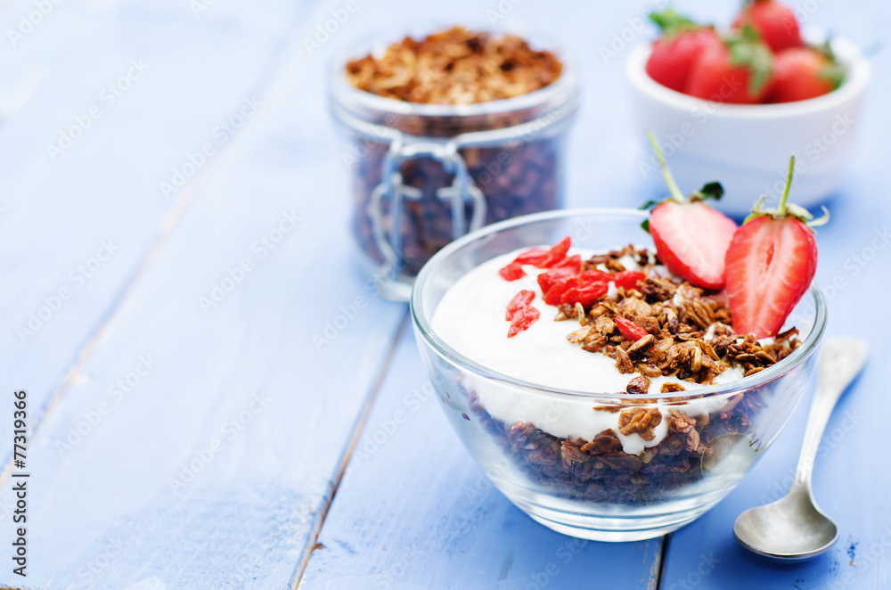fresh breakfast of granola, yogurt, nuts, goji berries and straw fresh breakfast of granola, yogurt, nuts, goji berries and straw