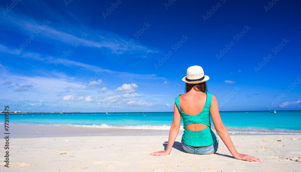 Young happy woman on beach during her summer vacation Young happy woman on beach during her summer vacation