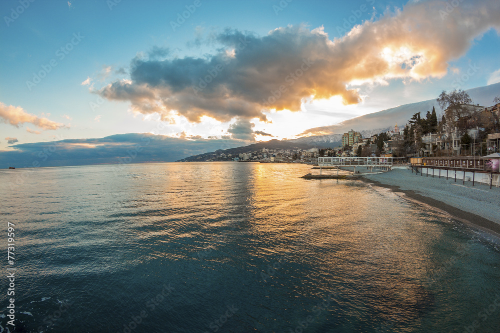 Beautiful sunset over the sea with mountain city, Yalta