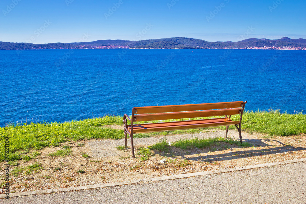 Empty bench by the sea