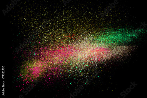 Colorful powder explosion cloud concept on dark background 