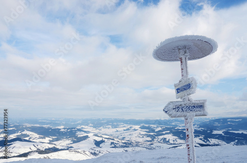 Frozen direction sign at Gimba mountain,winter time,Carpathians