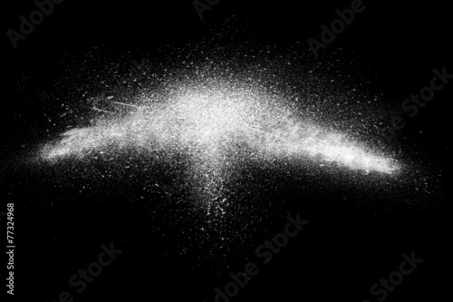 Freeze motion of white powder exploding black background 