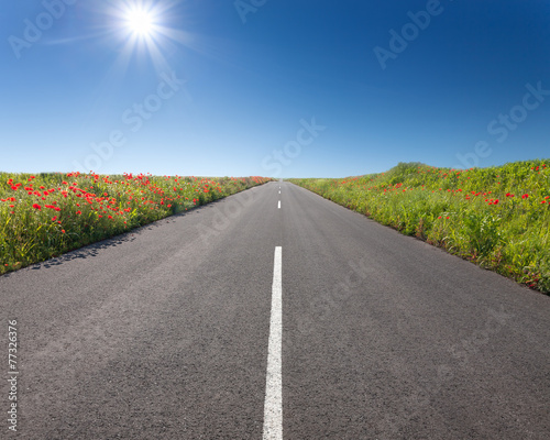 Driving on an empty road at sunny day