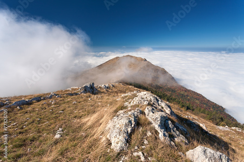 Mountain landscape above the clouds photo