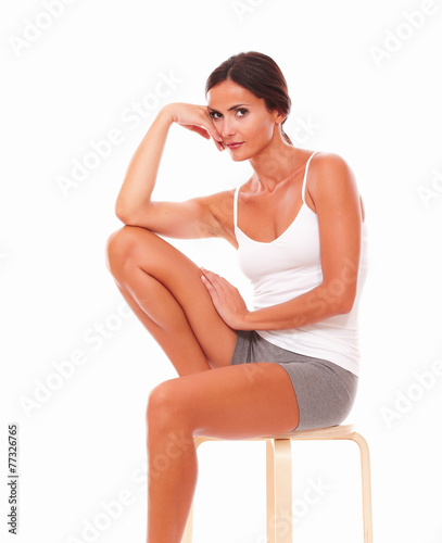 Adult woman sitting and looking at you