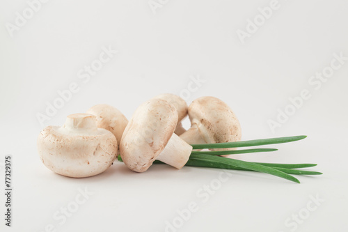 Raw mushrooms and onion leaves