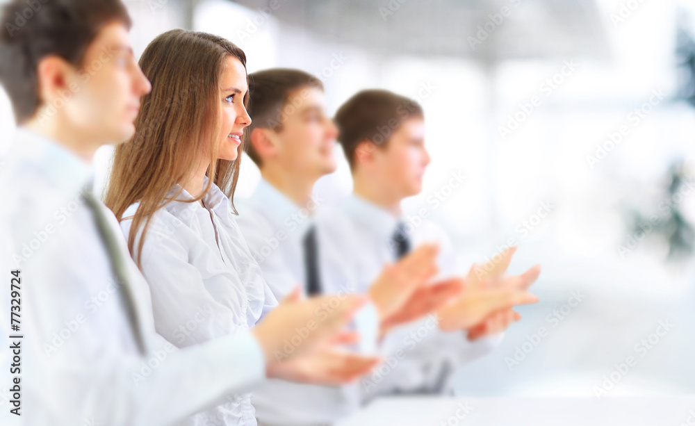 Happy business group applauding at the office Happy business group applauding at the office