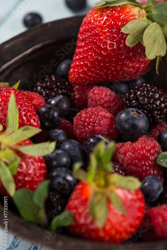 Rustic bowl with fresh summer berries fruits