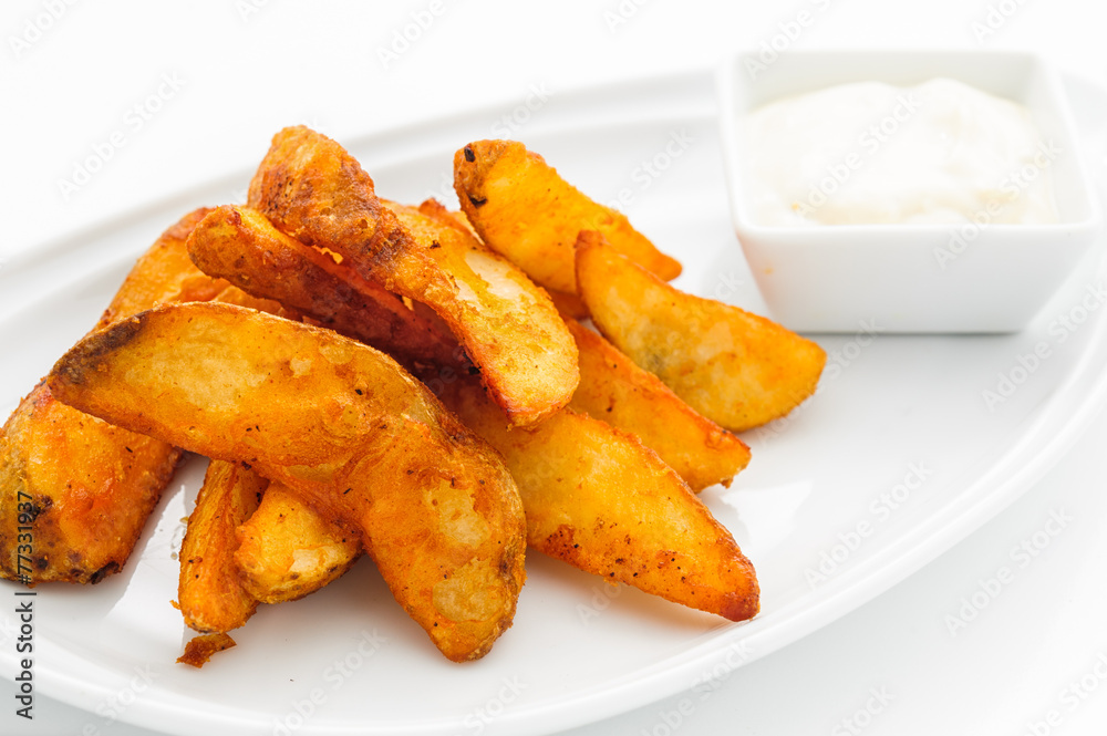Fried potatoes on white plate with sauce Fried potatoes on white plate with sauce