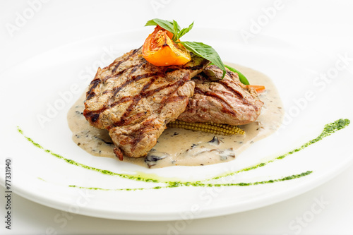 Grilled steak on white plate