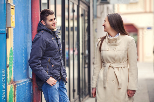 Young man and woman flirting on the street