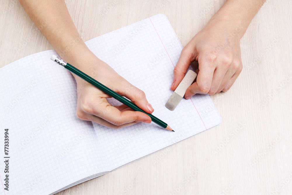 Human hands with pencil writing