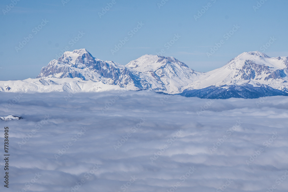 View on mountains and blue sky above clouds