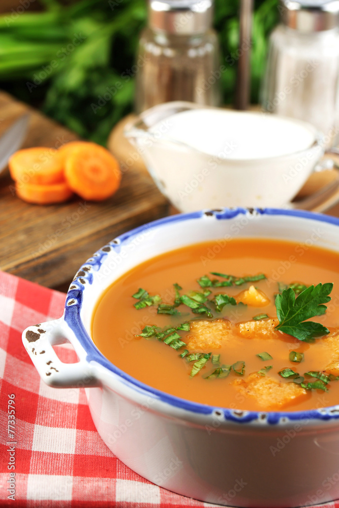 Composition with carrot soup, ingredients and herbs