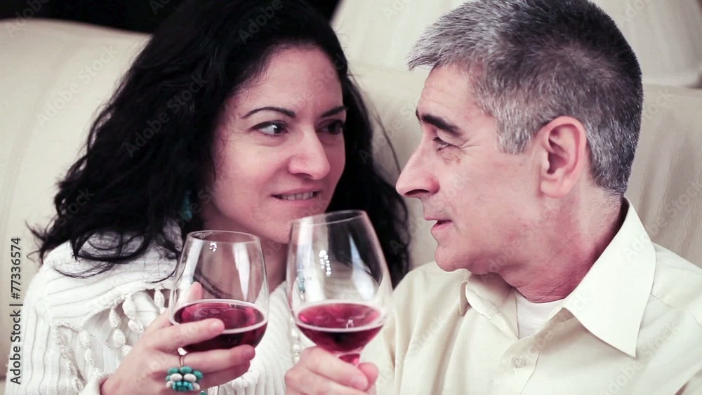 Couple Talking Closely And Toasting With Red Wine Couple Talking Closely And Toasting With Red Wine