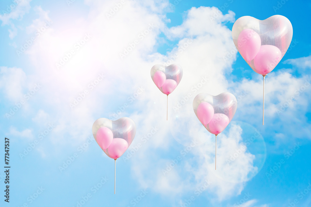 Heart shaped balloon on blue sky