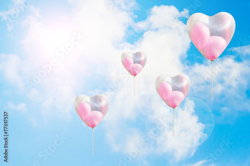 Heart shaped balloon on blue sky