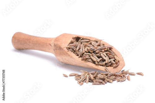 Caraway seed in an olive wood scoop