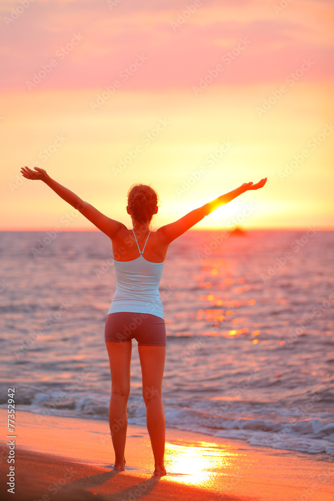 Happy freedom woman relaxing at beach sunset