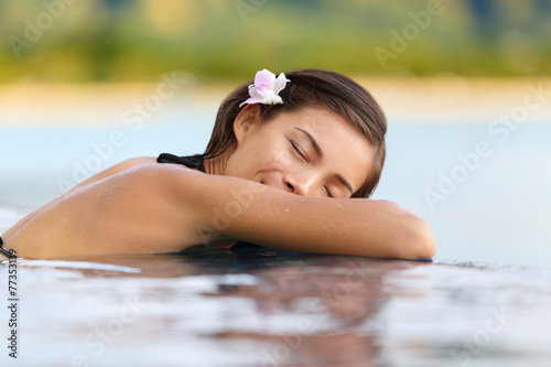 Relaxing pool woman on holidays - vacation travel